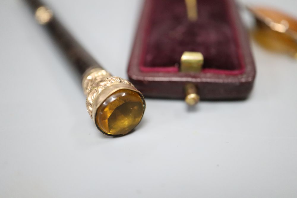 An early 20th century gold plate mounted propelling pencil, an agate set brooch, a 9ct gold and enamel medallion and a fox head pin.